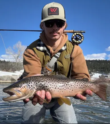 paden-e1776790721302 Angler holding large brown trout on winter guided fly fishing trip San Juan River Pagosa Springs Colorado